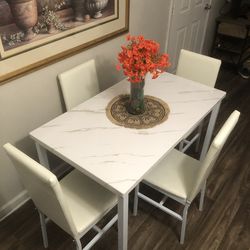 White faux marble dining table set with 4 leather chairs