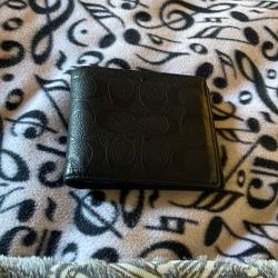 •	Coach Signature Debossed Leather Bifold Wallet