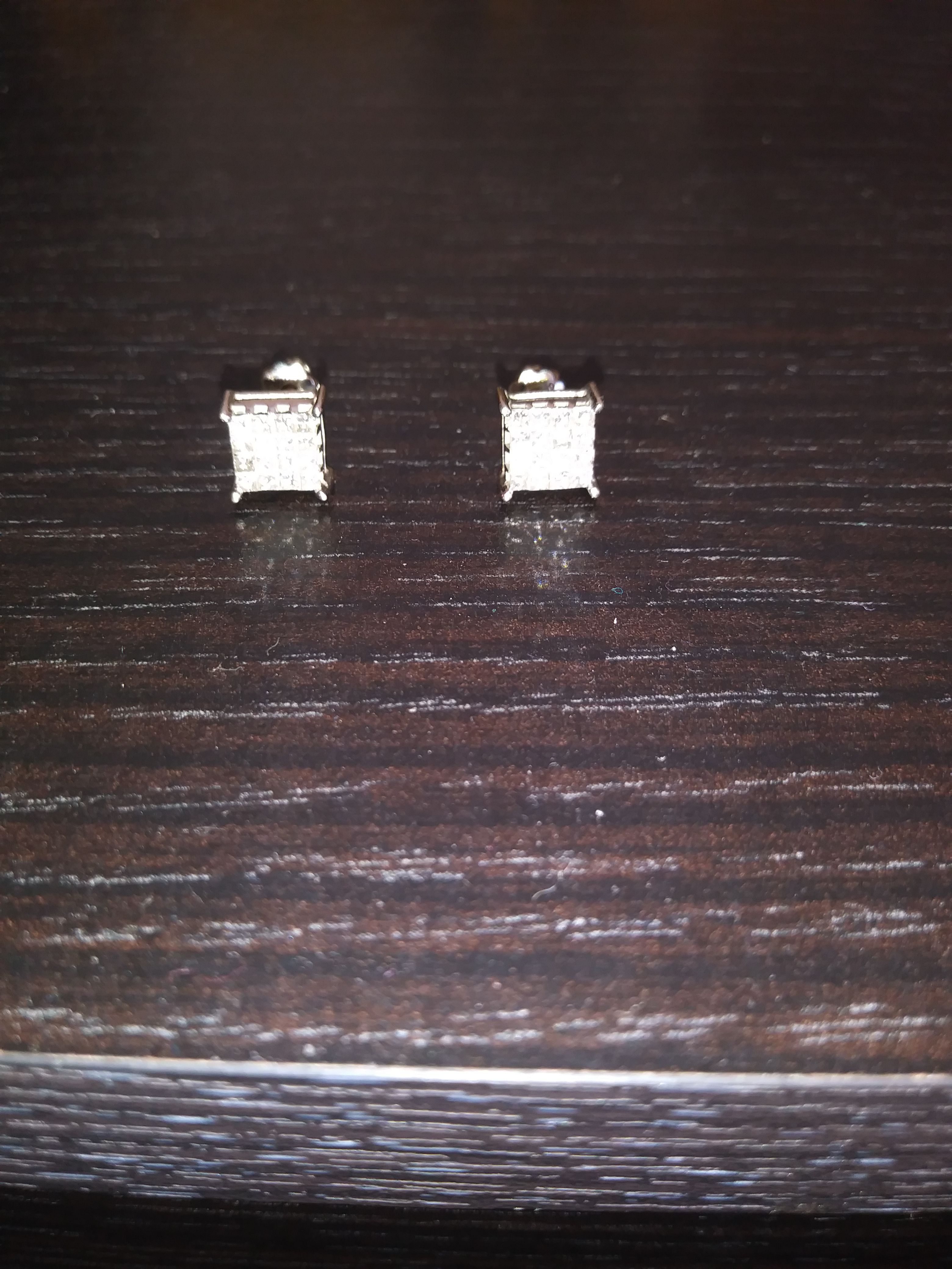 2 diamond earings. Princess Dia cut. 0.75 carats a piece. 1.50 total. Still have paper work for them.