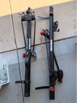 two Yakima fork-mount rooftop bike carriers with keys