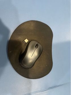 Black wireless mouse with USB receiver included and mouse pad