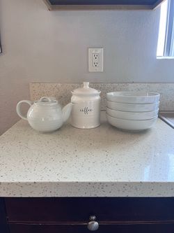 White ceramic teapot, coffee canister, and 4 bowls