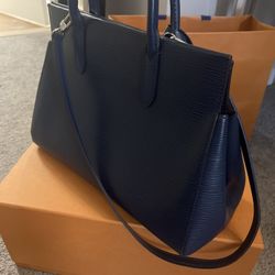 The Louis Vuitton Indigo Epi Leather Marly MM bag is a dark blue