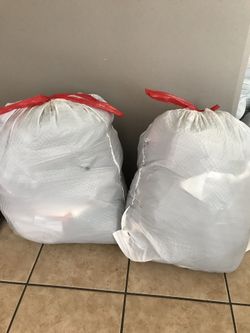 2 bags full of girl clothes and 2 other full bags filled with guy clothes