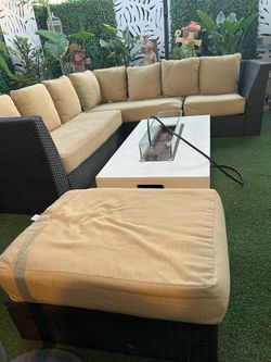 Beautiful rattan patio set in very good condition; the cushions need cleaning. The fire pit is not included.