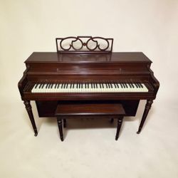 Cable-Nelson console studio upright piano with a mahogany finish
