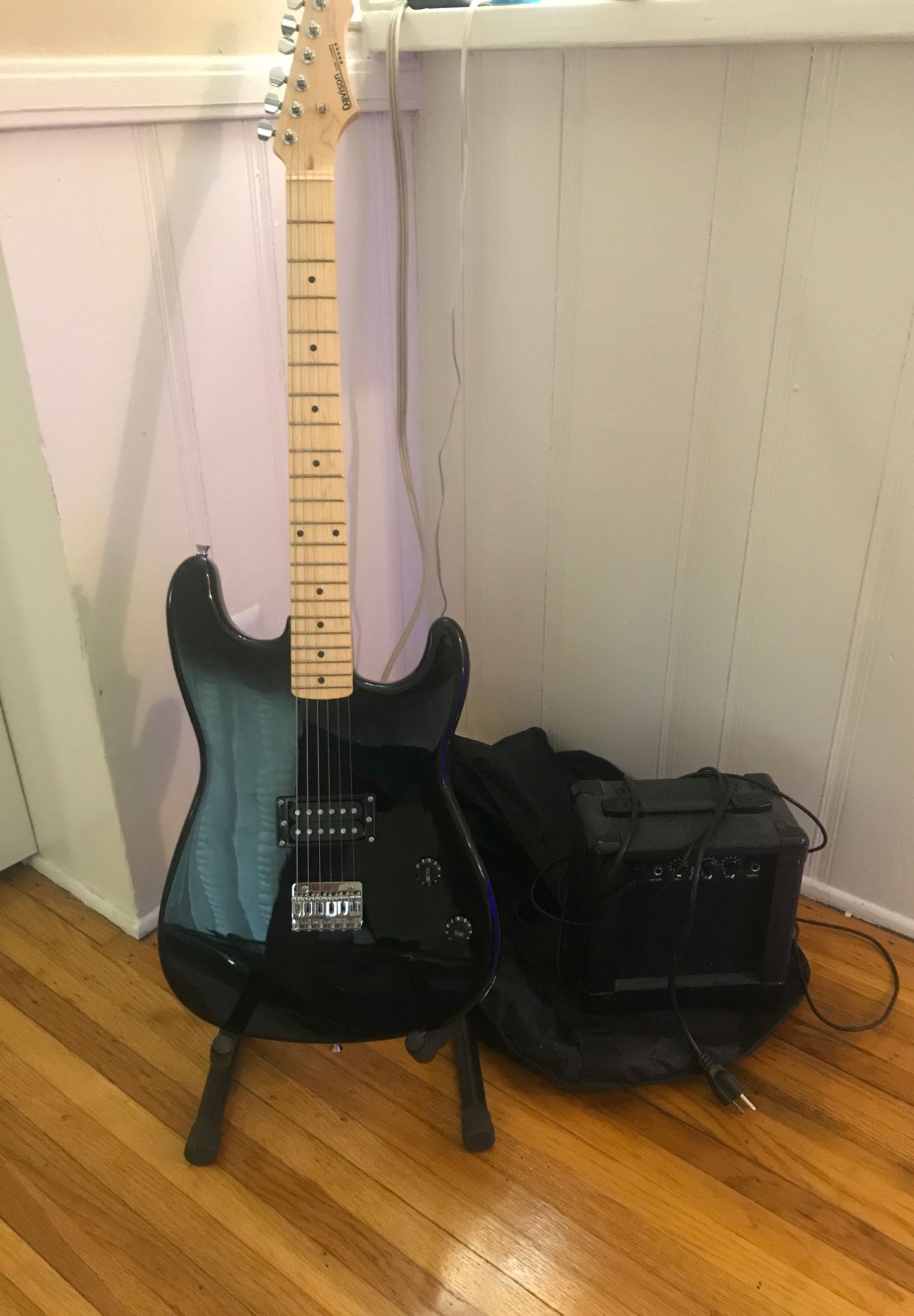 Gently used black electric guitar