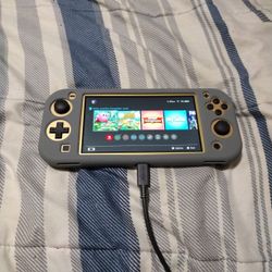 Nintendo Switch Lite (Hyrule Edition) with accessories & games