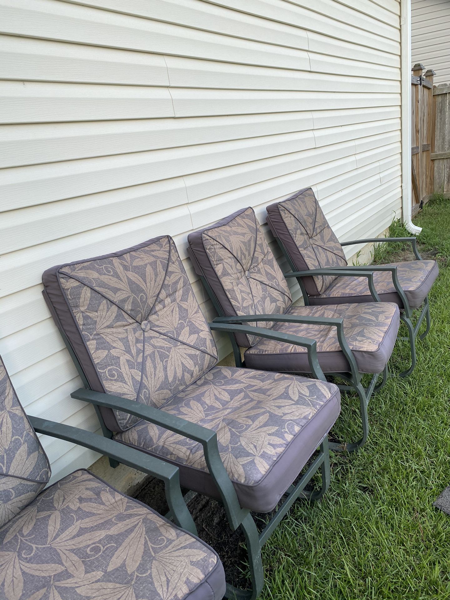 Dark green metal outdoor chairs with cushions