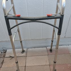 Drive Medical Two-Button Folding Walker with front wheels.