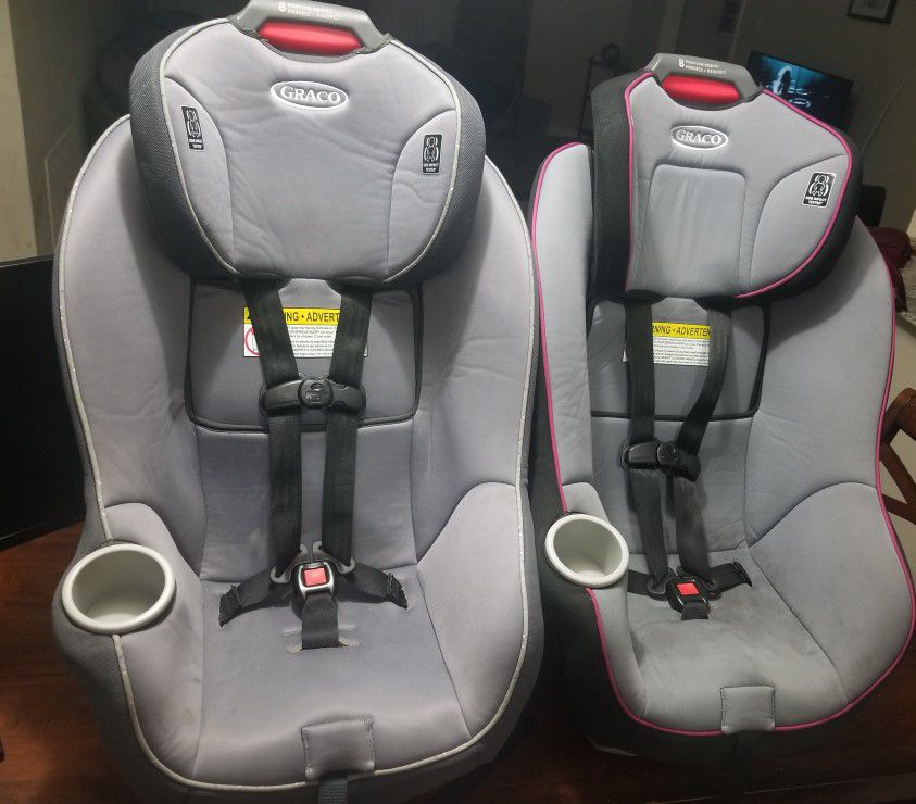 2 GRACO 8 position adjustable car seats ( 1 Pink and 1 Green) with harness,side impact and headrest