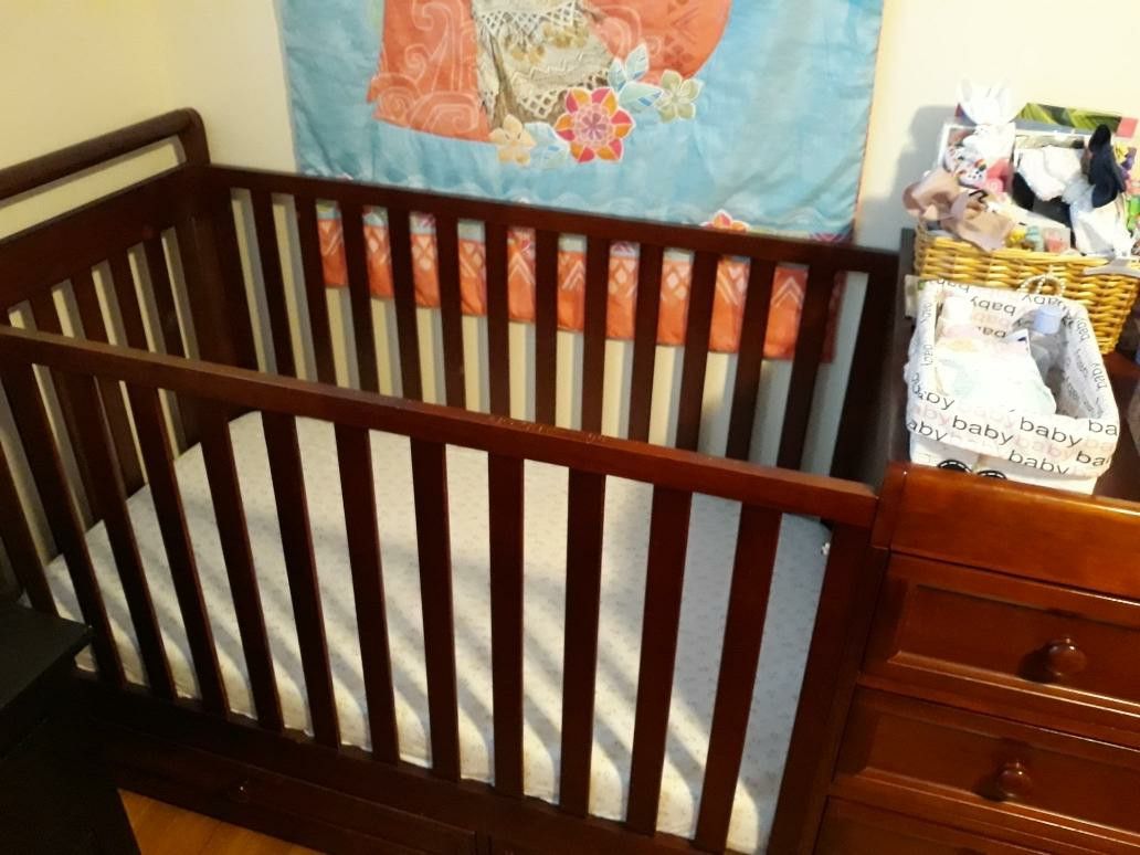 Crib converted to toddler bed with changing table draws