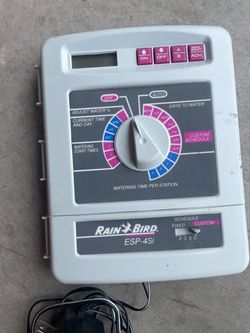 Rain Bird ESP-4Si irrigation controller (sprinkler timer) with a dial, digital display, and programming buttons