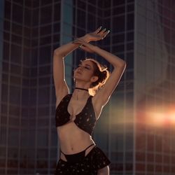 Black and gold glittery rhinestone backless halter neck top set with matching micro-skirt. 