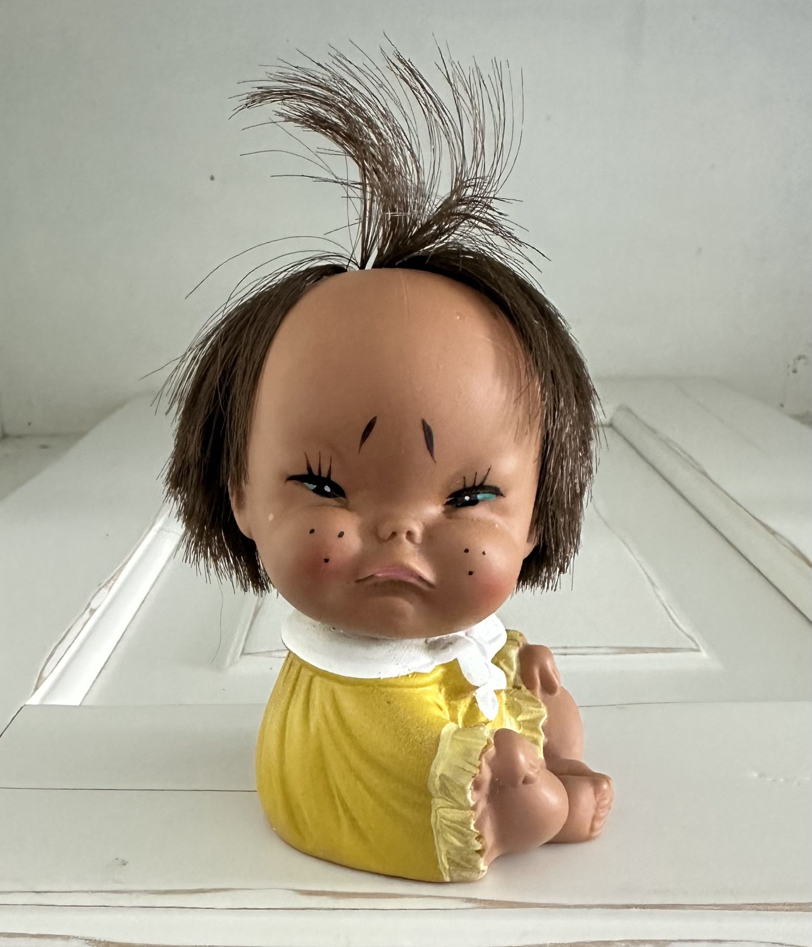 Vintage 1960s Japan Grumpy Collectible Rubber Toy Moody Cutie Doll Yellow Dress Grumpy face Brown sticky up hair Yellow dress Head twists to pose