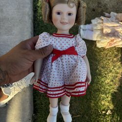 collectible Shirley Temple porcelain doll likely produced by the Danbury Mint.  It is part of the "Dolls of The Silver Screen" series.  The doll is ap