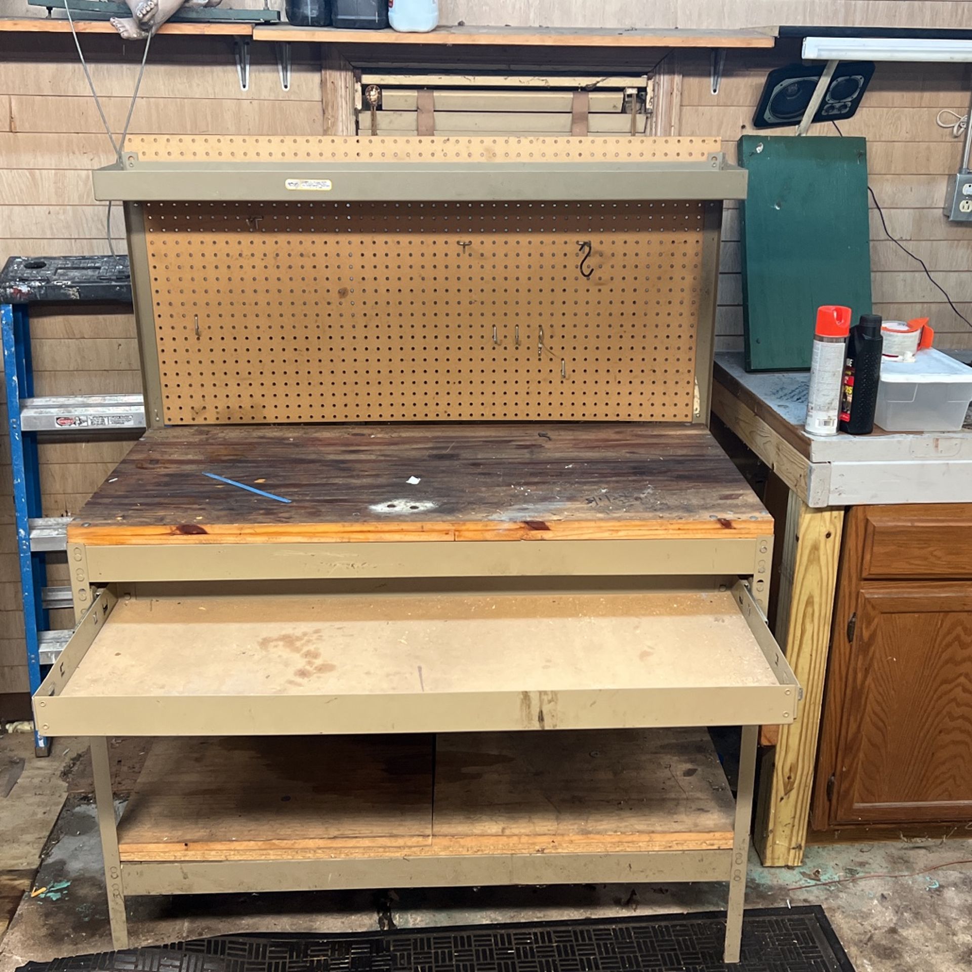 Steel frame wood top workbench, top shelf bottom shelf steel drawer. Pegboard backing