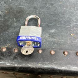 This is a Brinks 40mm Laminated Steel Padlock. It is designed for heavy-duty use and features a chrome-plated, hardened steel shackle for increased cu
