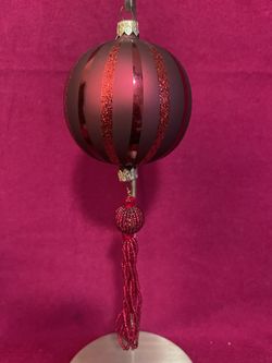 Vintage glass Christmas ornament with glitter stripes and a beaded tassel