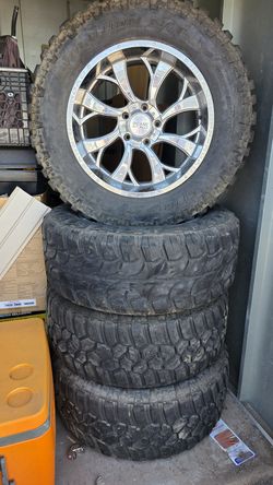 set of four Cooper Evolution M/T tires (35x12.50R20LT) mounted on chrome Insane Off-Road wheels