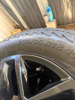 275/65 R18 Tire on Black Alloy Wheel