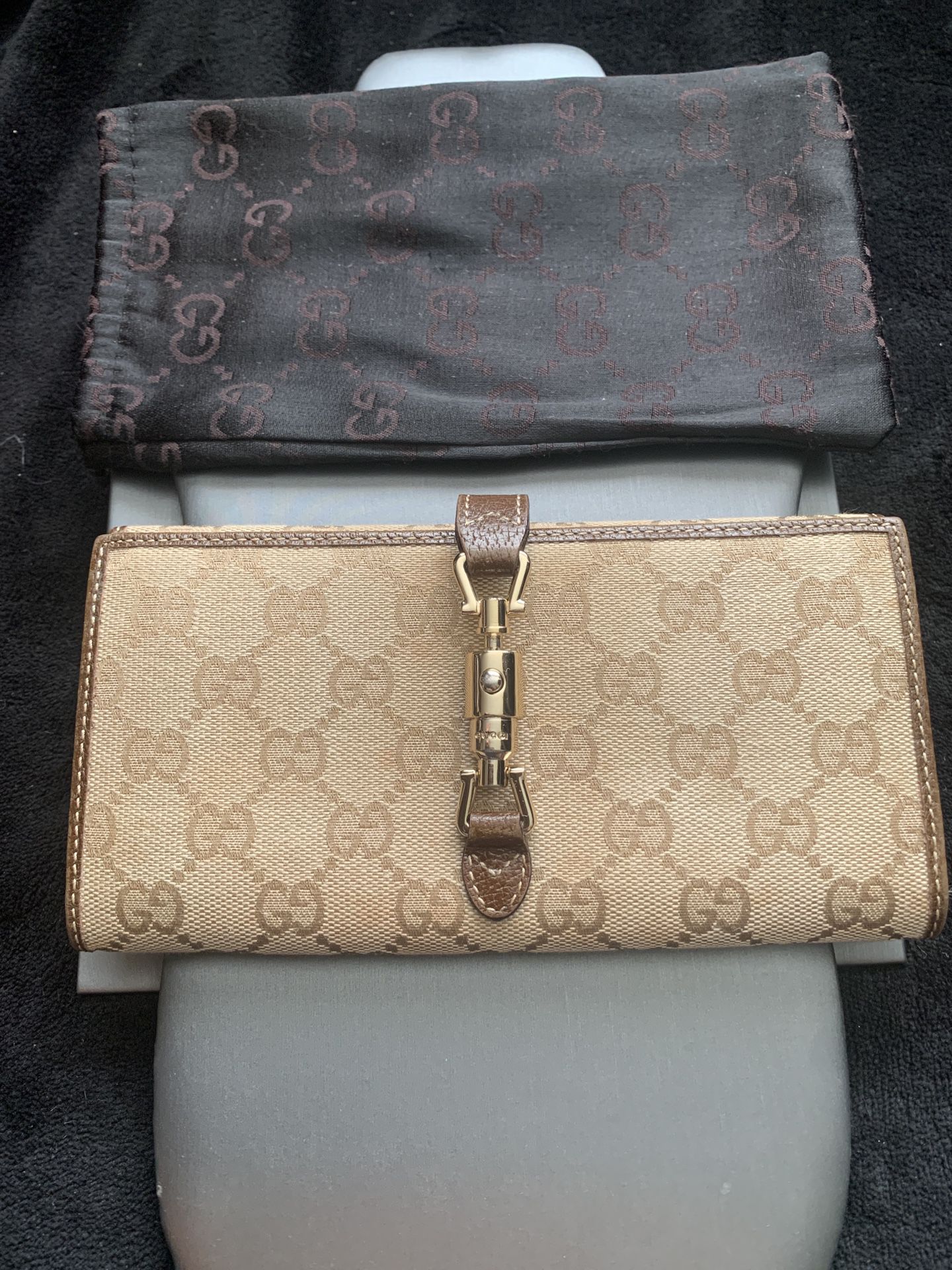 Authentic Gucci monogramed wallet with dust bag.