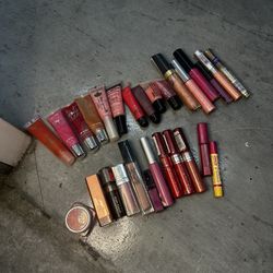 Variety of lip glosses and lipsticks in different shades. Some are used some are new  