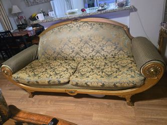 A wooden furniture set: one three-seater sofa and two armchairs.