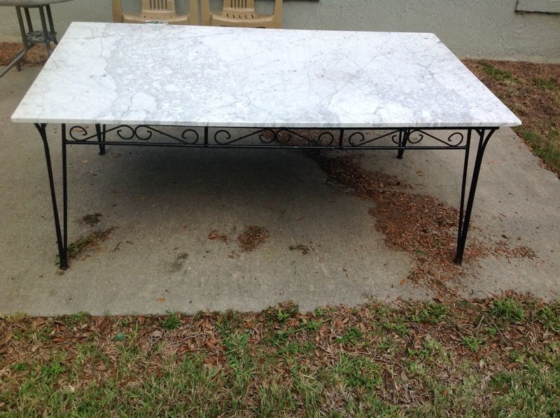 Patio table with marble top and wrought iron legs