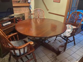 Large rounded dining room table and matching chairs