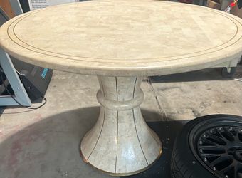 Tessellated stone pedestal dining table