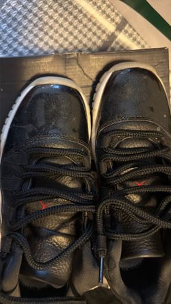 Air Jordan 11 Black Patent Leather Sneakers