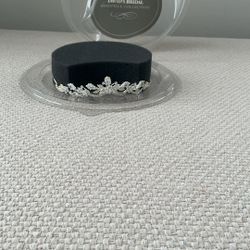 A semi-circular, jeweled headpiece