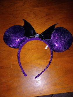 Purple Mouse Ears Headband with Bat Wings
Purple sequined mouse ears headband with black bat wings and a bow.