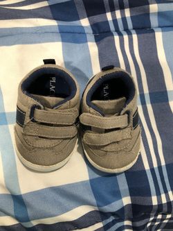 The children place shoes size 3/6 mos