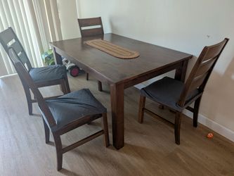 brown wood dining table and  4 chairs