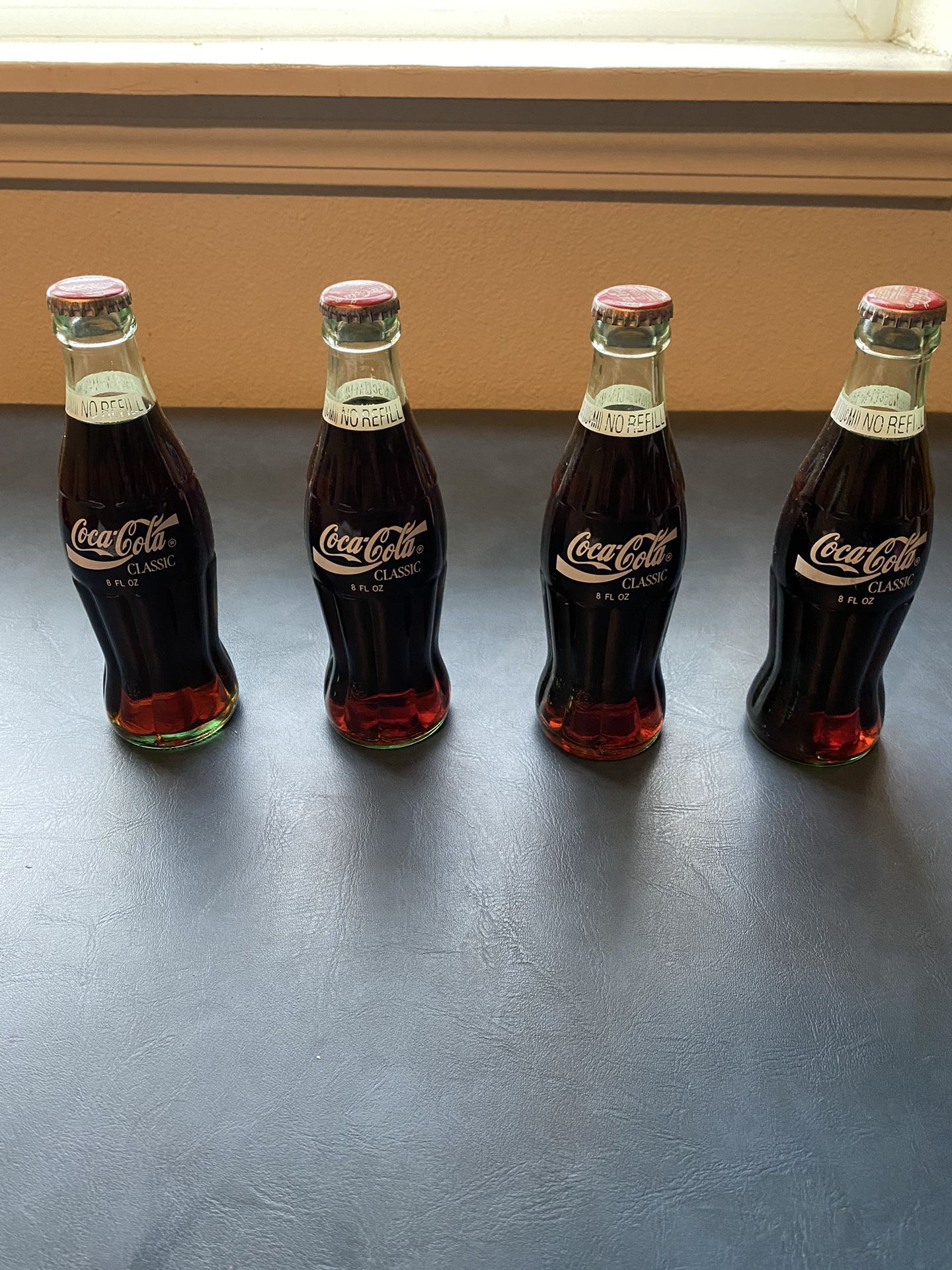 4 Coca Cola Bottles