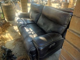 Leather sofa with phone chargers and auxiliary