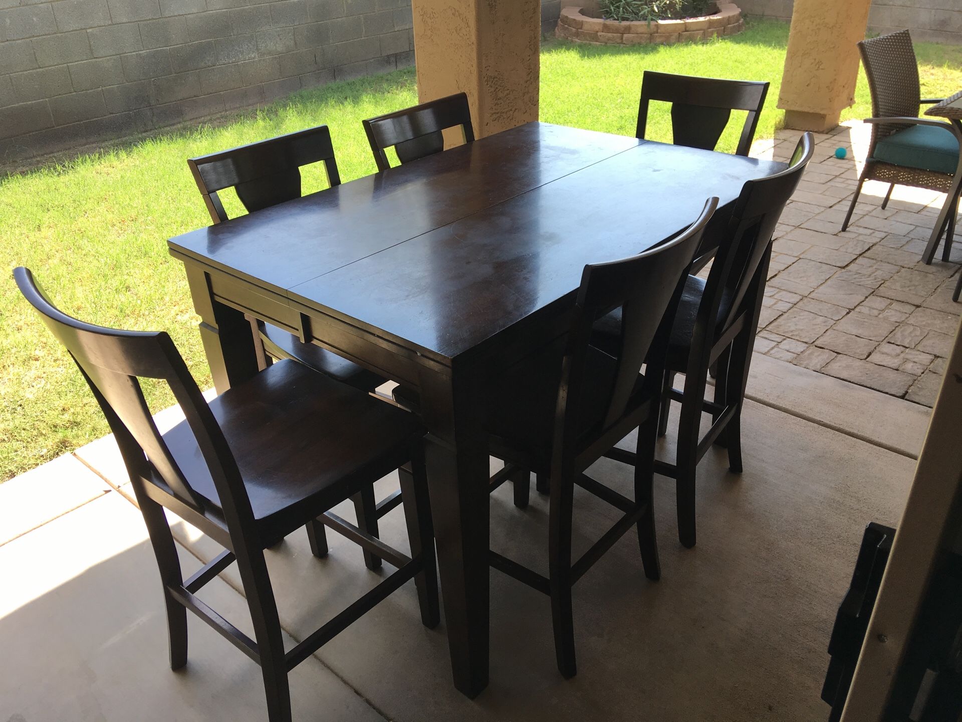 Oak finish dining room table. Bar height style