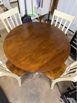 Round wooden dining room table with chairs
