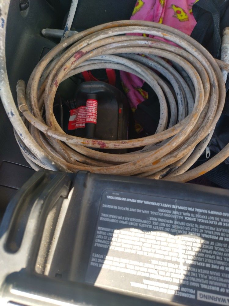 Air Compressor And Nail Gun Hoses And Also Two Drill Bits For Industrial Drills