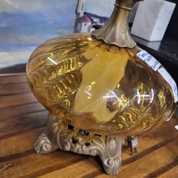 Vintage amber glass table lamp. Base lights as well as the regular light bulb