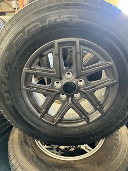 Set of 4 used wheels and tires for jeep 5x127 tire size 245/75/17 Bridgestone