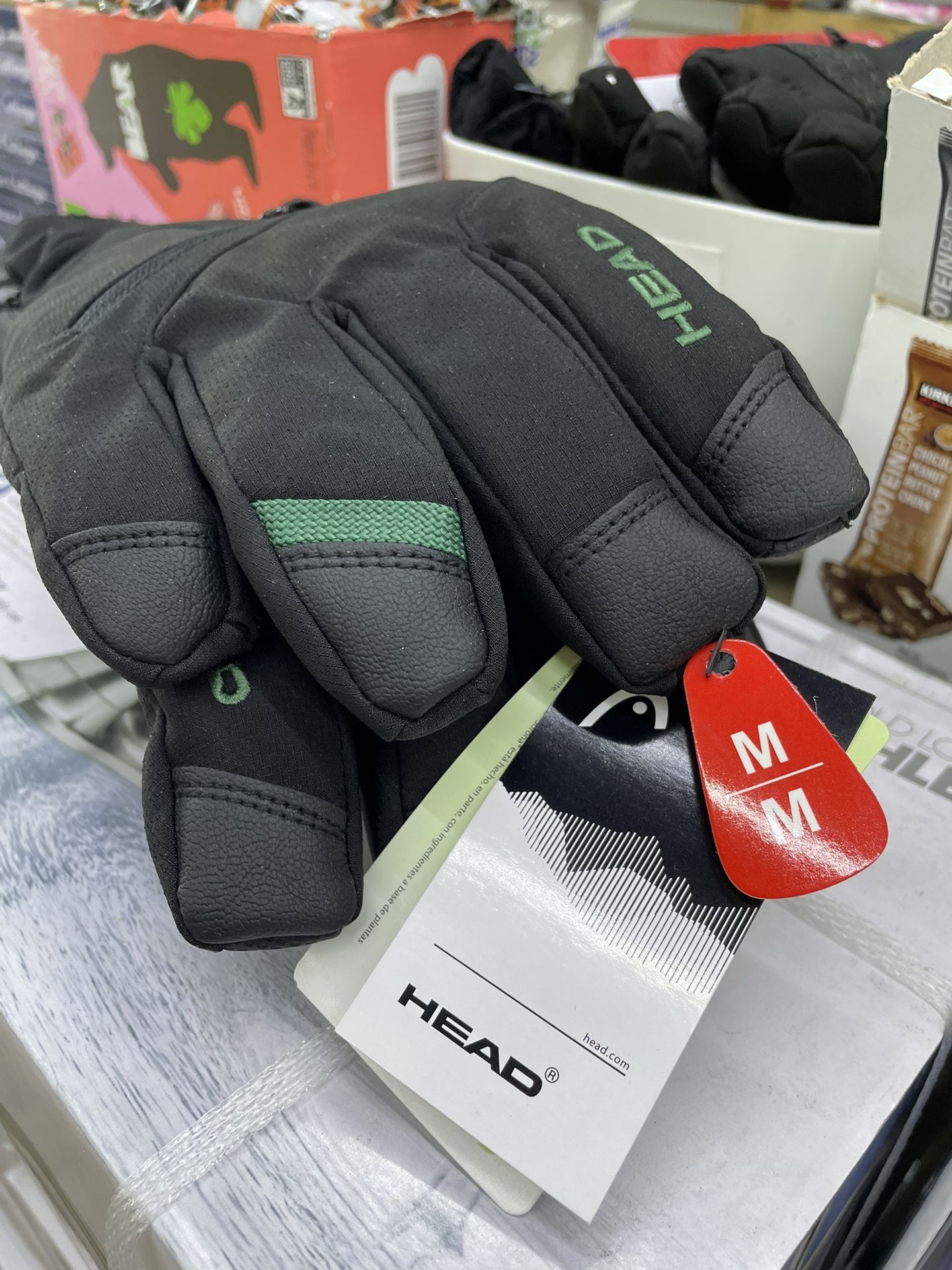 pair of HEAD brand gloves, specifically featuring touchscreen-compatible technology and silicone grips.
