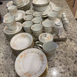 Noritake Inspiration dinnerware set, featuring a pattern w/orange/yellow flowers & gold trim.This pattern was discontinued in 1983..8-12 Setting