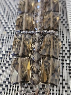 This is a faceted smoky quartz and sterling silver bracelet featuring a box clasp. 