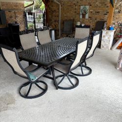 Hanover Fontana 7 -Piece Bronze Patio Dining Set Aluminum Rectangle Table with 6 Tan Swivel Rocker Chairs