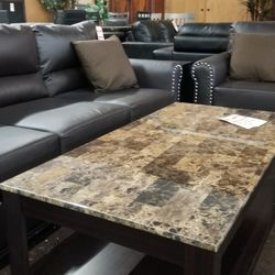 Dark brown faux leather sofa and loveseat with pinheads