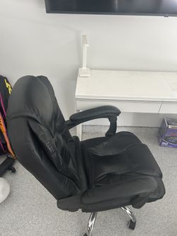 IKEA desk with glass top for computer and office chair.