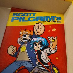 +2

The object in the image is Scott Pilgrim's Precious Little Card Game, a deck-building card game.
